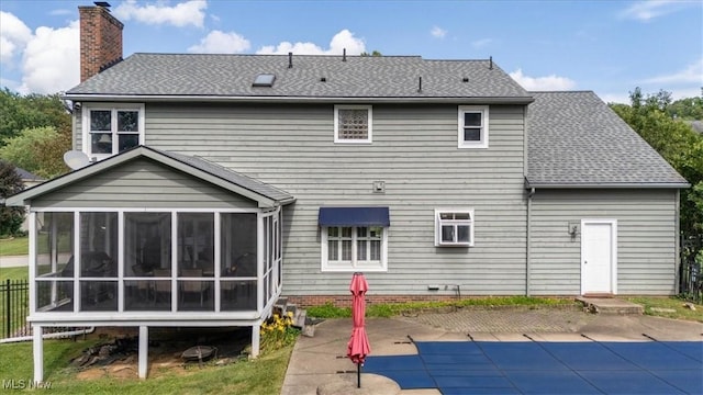 1103 Greenmont Cir, Vienna, WV 26105 - back of property featuring a sunroom, a patio area, a chimney, and a covered pool