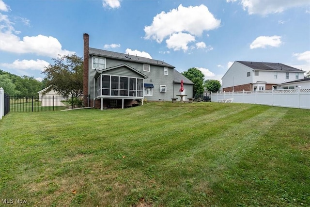 1103 Greenmont Cir, Vienna, WV 26105 - rear view of property featuring a sunroom, a chimney, and a fenced backyard