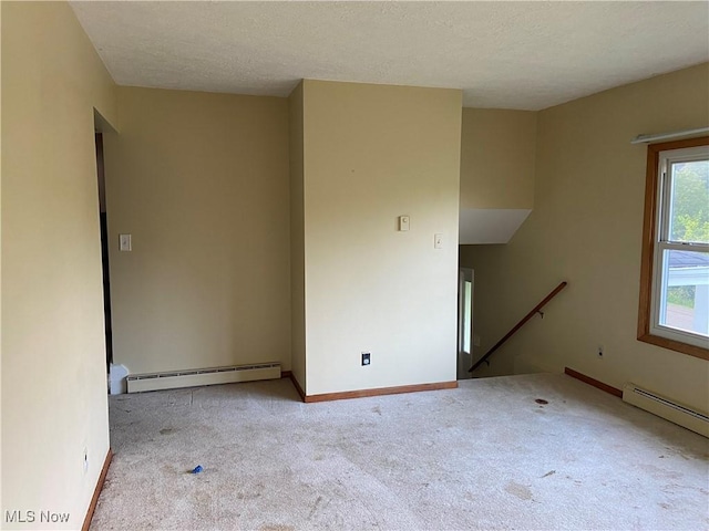 100 Crestview Dr, Newcomerstown, OH 43832 - spare room with a baseboard heating unit, carpet floors, and a textured ceiling