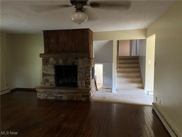 100 Crestview Dr, Newcomerstown, OH 43832 - unfurnished living room with a baseboard heating unit, a textured ceiling, hardwood / wood-style flooring, ceiling fan, and stairs