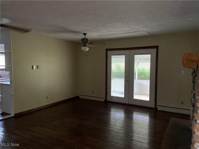 100 Crestview Dr, Newcomerstown, OH 43832 - spare room with a baseboard heating unit, french doors, hardwood / wood-style flooring, healthy amount of natural light, and a textured ceiling
