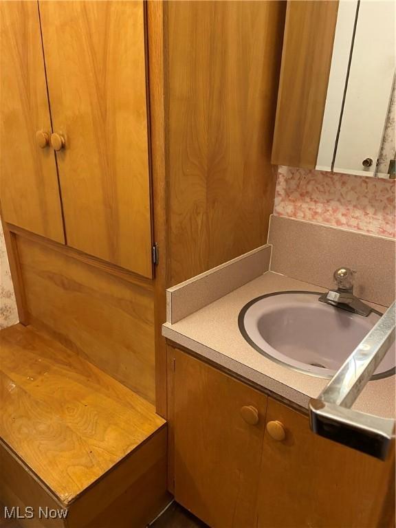 100 Crestview Dr, Newcomerstown, OH 43832 - bathroom featuring vanity and wallpapered walls