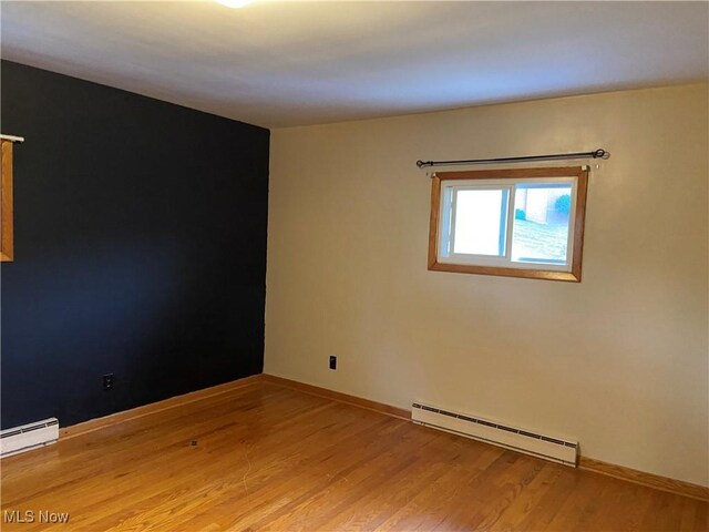 100 Crestview Dr, Newcomerstown, OH 43832 - empty room featuring a baseboard radiator and light wood-style floors
