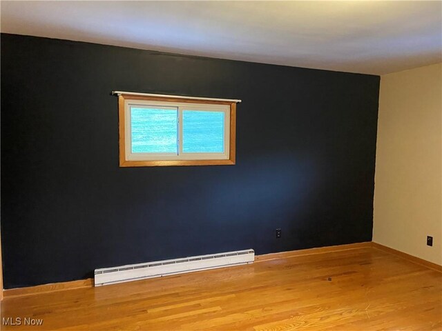 100 Crestview Dr, Newcomerstown, OH 43832 - unfurnished room with a baseboard radiator and wood finished floors