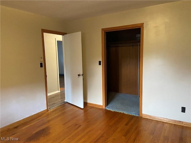 100 Crestview Dr, Newcomerstown, OH 43832 - unfurnished bedroom featuring wood finished floors and baseboards