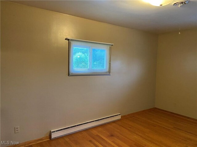 100 Crestview Dr, Newcomerstown, OH 43832 - unfurnished room with baseboard heating and wood finished floors