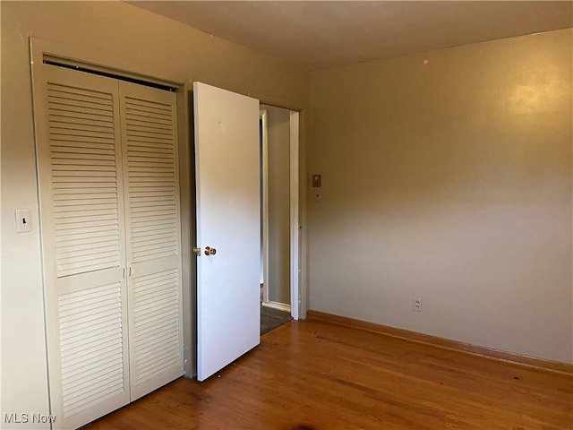 100 Crestview Dr, Newcomerstown, OH 43832 - unfurnished bedroom with a closet and wood finished floors
