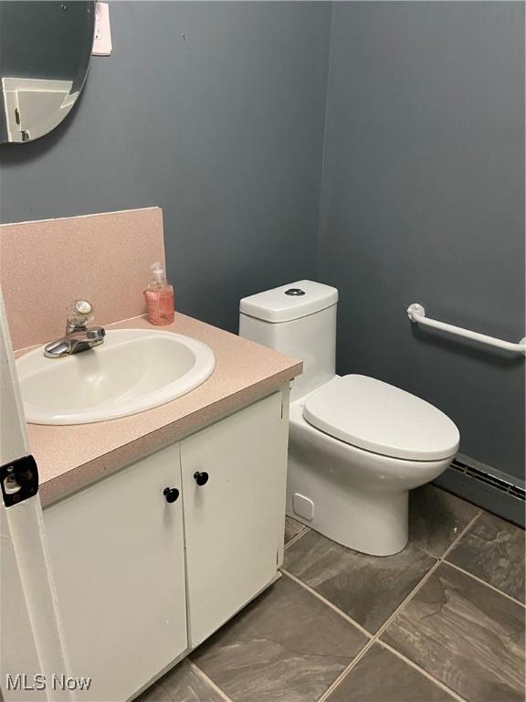 100 Crestview Dr, Newcomerstown, OH 43832 - bathroom featuring vanity and a baseboard heating unit