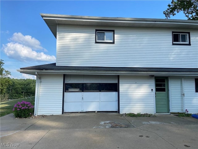100 Crestview Dr, Newcomerstown, OH 43832 - view of side of property with an attached garage and driveway