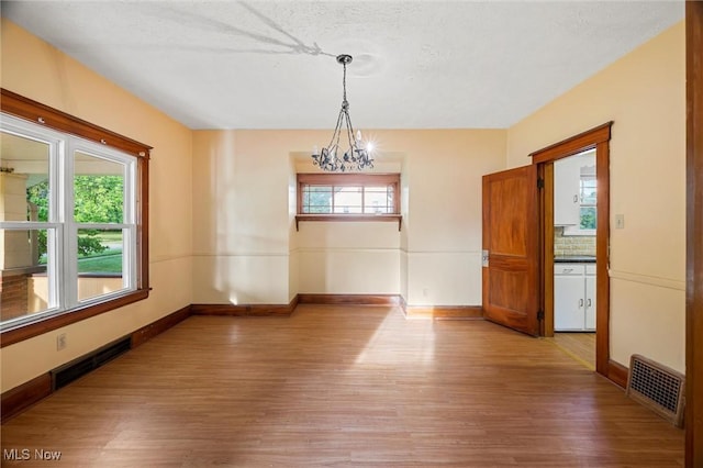 57 Charles Ave, Boardman, OH 44512 - spare room featuring light wood-type flooring and a chandelier