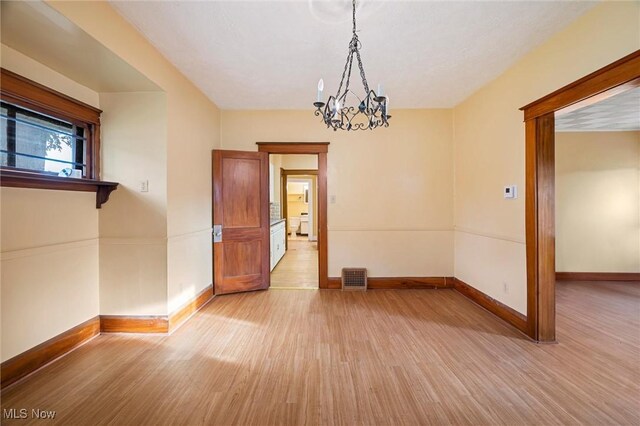 57 Charles Ave, Boardman, OH 44512 - unfurnished room featuring light wood-style flooring and a chandelier