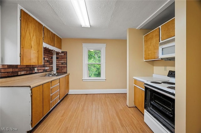 57 Charles Ave, Boardman, OH 44512 - kitchen with white appliances, brown cabinets, light wood-type flooring, light countertops, and a textured ceiling