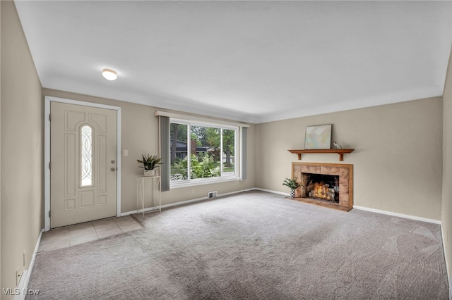 484 E 319th St, Willowick, OH 44095 - foyer with carpet, a tiled fireplace, and tile patterned floors