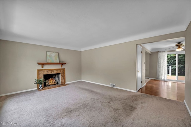 484 E 319th St, Willowick, OH 44095 - unfurnished living room featuring carpet flooring, a tile fireplace, and a ceiling fan