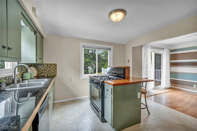 484 E 319th St, Willowick, OH 44095 - kitchen featuring green cabinetry, black range with gas stovetop, decorative backsplash, a kitchen bar, and dishwasher