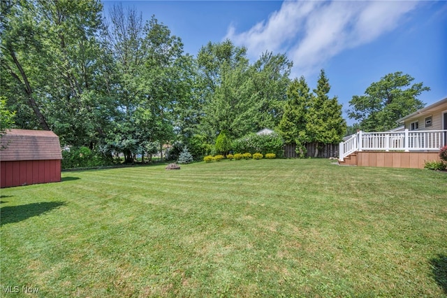 484 E 319th St, Willowick, OH 44095 - view of green lawn featuring a storage unit and a deck