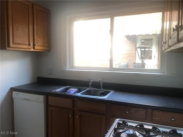 204 Beech Rd, Weirton, WV 26062 - kitchen featuring dishwasher, dark countertops, plenty of natural light, and brown cabinets