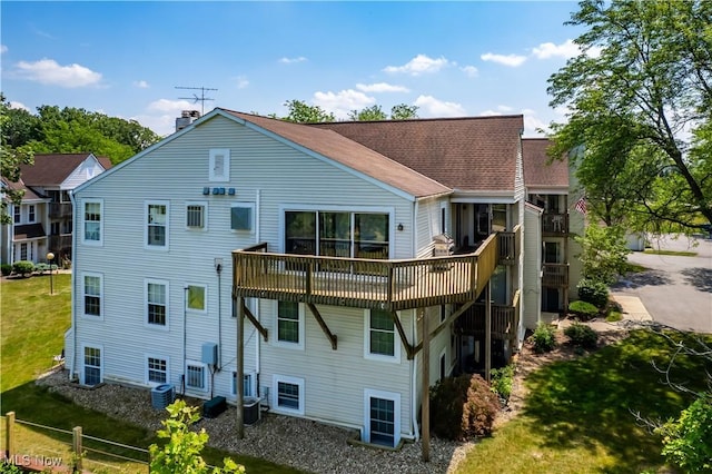 1217 W River Rd N Unit A3, Elyria, OH 44035 - back of house featuring a yard, a wooden deck, a chimney, and a shingled roof