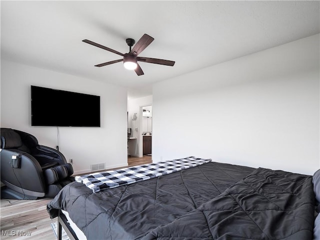 1217 W River Rd N Unit A3, Elyria, OH 44035 - bedroom with light wood-style flooring, a ceiling fan, and ensuite bath