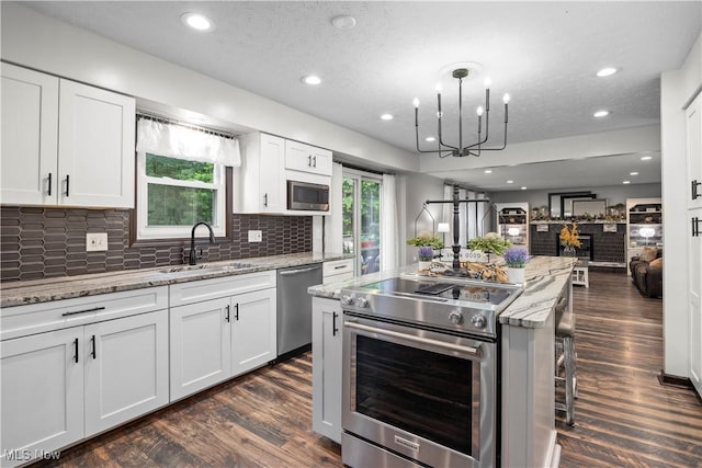 26938 Tall Oaks Trl, Olmsted Twp, OH 44138 - kitchen featuring stainless steel appliances, open floor plan, dark wood finished floors, tasteful backsplash, and recessed lighting