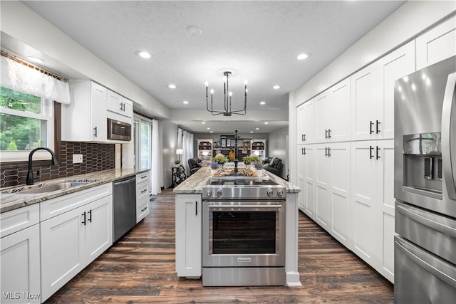 26938 Tall Oaks Trl, Olmsted Twp, OH 44138 - kitchen with appliances with stainless steel finishes, open floor plan, healthy amount of natural light, light stone counters, and recessed lighting