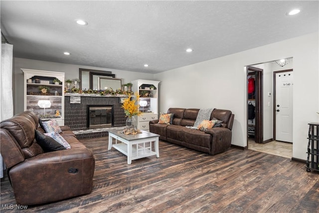 26938 Tall Oaks Trl, Olmsted Twp, OH 44138 - living room featuring wood finished floors, recessed lighting, a fireplace, and a textured ceiling