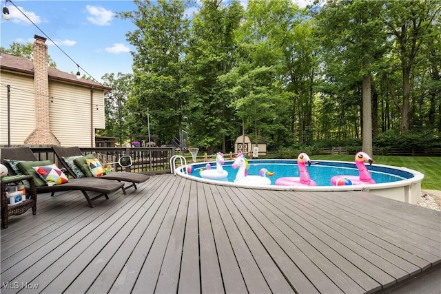 26938 Tall Oaks Trl, Olmsted Twp, OH 44138 - outdoor pool with a deck, a storage unit, and view of wooded area