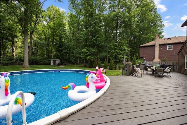 26938 Tall Oaks Trl, Olmsted Twp, OH 44138 - swimming pool with a deck, outdoor dining space, and a storage shed