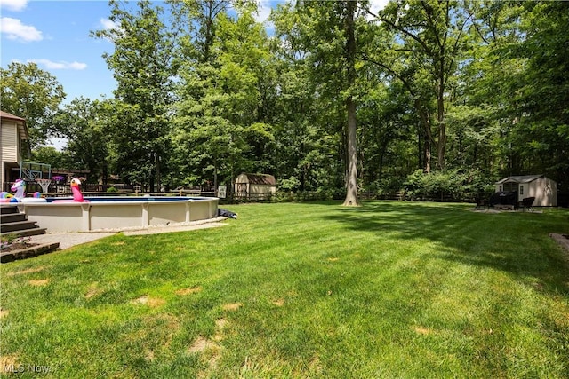 26938 Tall Oaks Trl, Olmsted Twp, OH 44138 - view of grassy yard with a shed and an outdoor pool