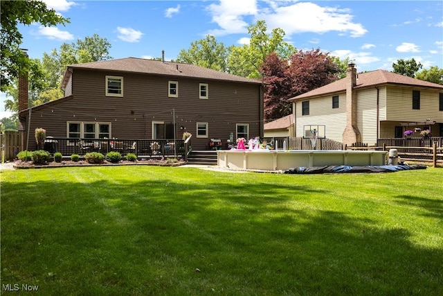 26938 Tall Oaks Trl, Olmsted Twp, OH 44138 - back of property with an outdoor pool, a deck, and a chimney