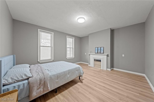 1411 E 47th St, Cleveland, OH 44103 - bedroom featuring wood finished floors and a textured ceiling