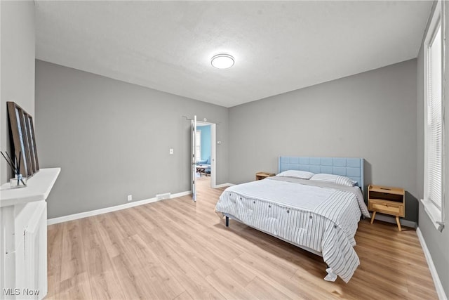1411 E 47th St, Cleveland, OH 44103 - bedroom with light wood-style flooring and baseboards