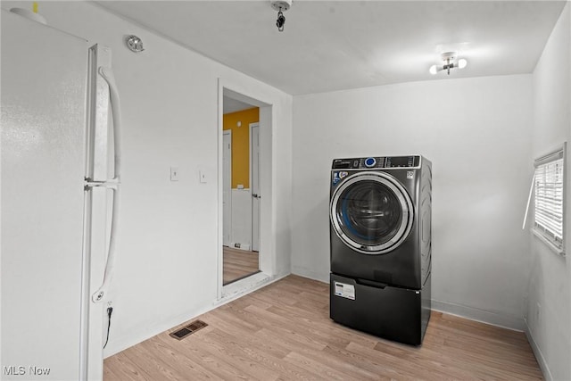 1411 E 47th St, Cleveland, OH 44103 - washroom featuring light wood finished floors and washer / dryer