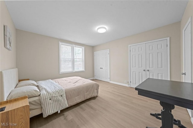 1411 E 47th St, Cleveland, OH 44103 - bedroom with multiple closets and light wood-style floors