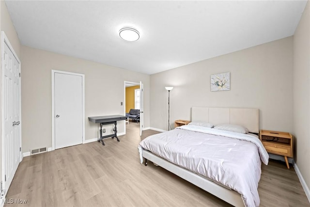 1411 E 47th St, Cleveland, OH 44103 - bedroom with light wood-style flooring and baseboards