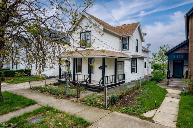 1411 E 47th St, Cleveland, OH 44103 - view of front facade with covered porch, a shingled roof, and a fenced front yard
