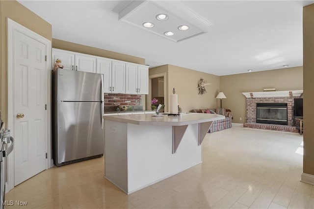 8883 Michaels Ln, Broadview Heights, OH 44147 - kitchen with freestanding refrigerator, open floor plan, white cabinetry, light countertops, and recessed lighting