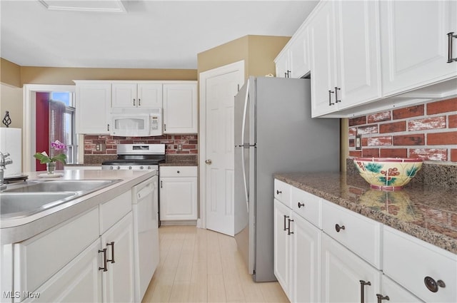 8883 Michaels Ln, Broadview Heights, OH 44147 - kitchen with appliances with stainless steel finishes, white cabinetry, and backsplash