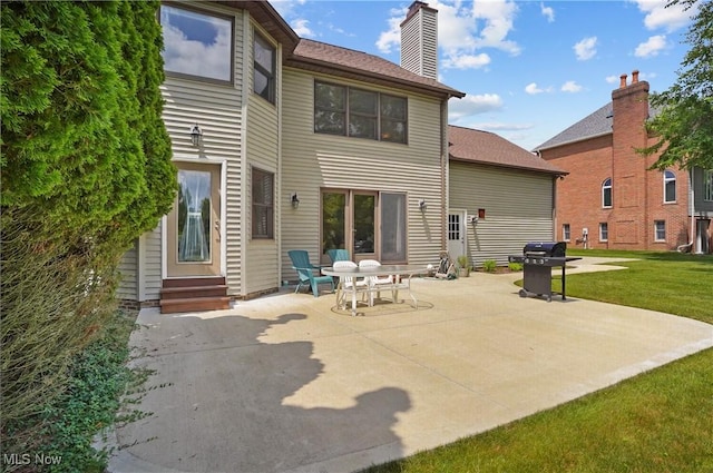 8883 Michaels Ln, Broadview Heights, OH 44147 - rear view of house with entry steps, a patio area, a yard, and a chimney