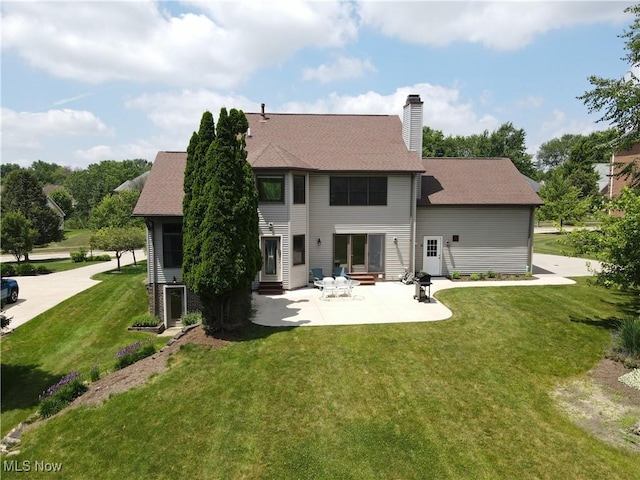 8883 Michaels Ln, Broadview Heights, OH 44147 - rear view of property featuring entry steps, a lawn, a chimney, and a patio
