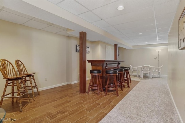 8883 Michaels Ln, Broadview Heights, OH 44147 - dining room featuring a bar, a drop ceiling, wood finished floors, and recessed lighting