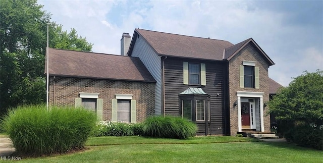 8883 Michaels Ln, Broadview Heights, OH 44147 - traditional home featuring a chimney, a front lawn, and brick siding