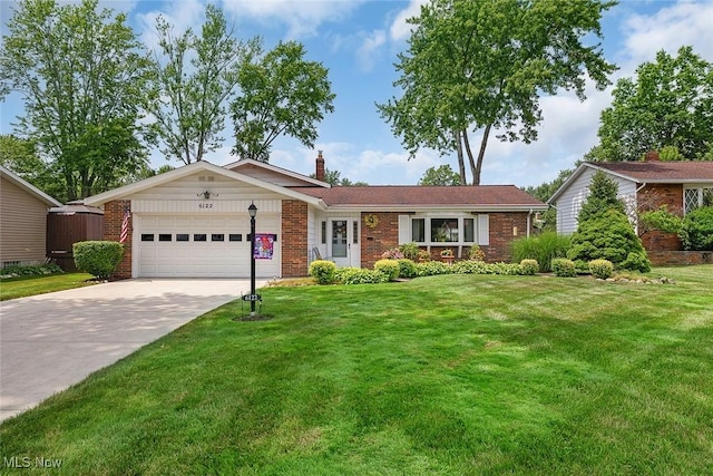 6122 Forest Ridge Dr, North Olmsted, OH 44070 - ranch-style house with a garage, brick siding, a chimney, driveway, and a front lawn