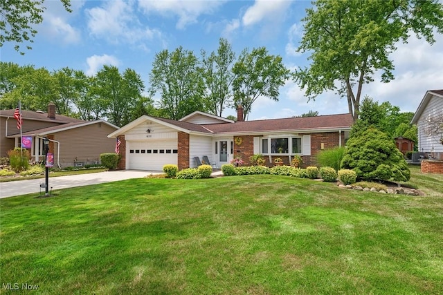 6122 Forest Ridge Dr, North Olmsted, OH 44070 - view of front of home featuring an attached garage, driveway, brick siding, a front lawn, and a chimney