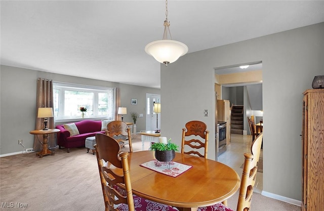 6122 Forest Ridge Dr, North Olmsted, OH 44070 - dining room with light colored carpet and stairs