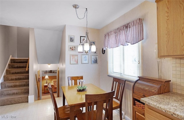 6122 Forest Ridge Dr, North Olmsted, OH 44070 - dining space with stairway and a chandelier