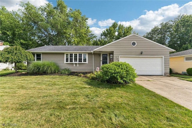 129 Whitman Blvd, Elyria, OH 44035 - ranch-style home featuring an attached garage, concrete driveway, and a front lawn