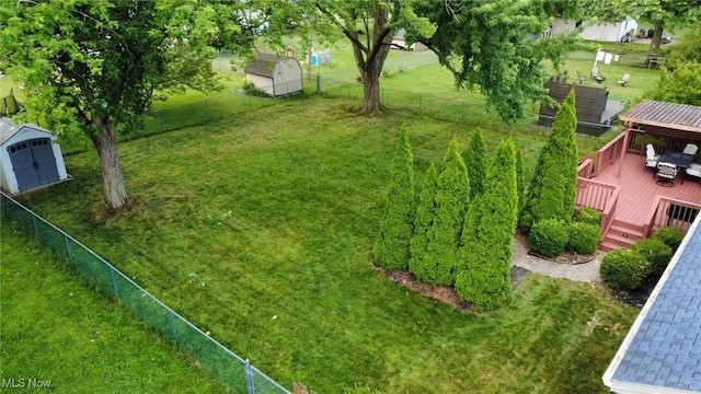 129 Whitman Blvd, Elyria, OH 44035 - fenced backyard featuring a deck and a storage shed