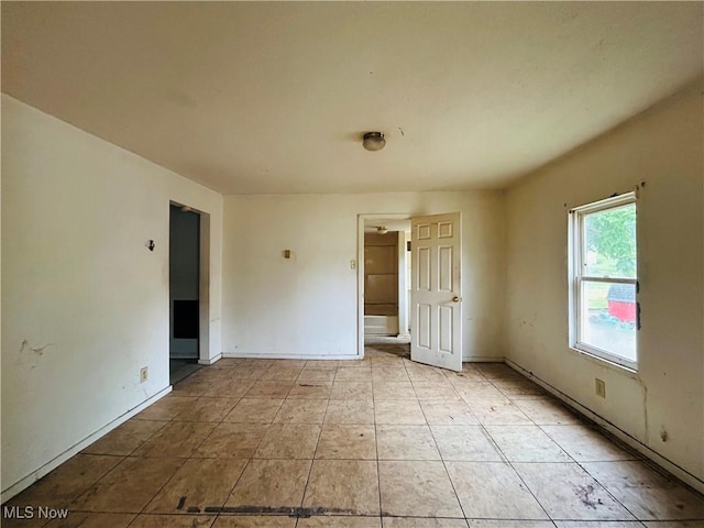 518 Jefferson Ave, Cambridge, OH 43725 - empty room featuring baseboards and light tile patterned floors