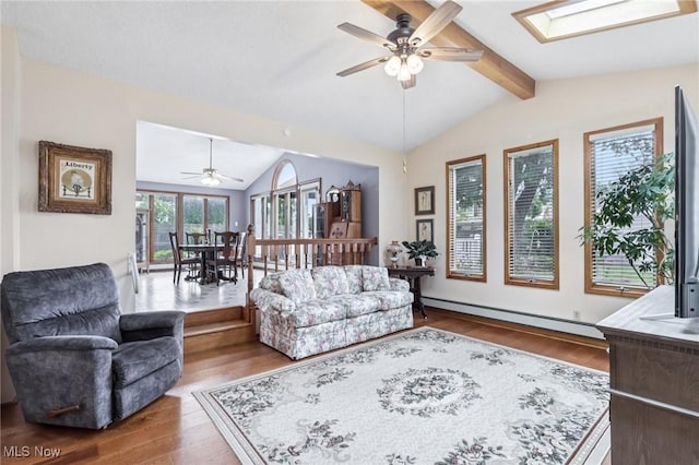 1318 Mirheath Dr, Huron, OH 44839 - living area with a ceiling fan, wood finished floors, a skylight, and baseboard heating